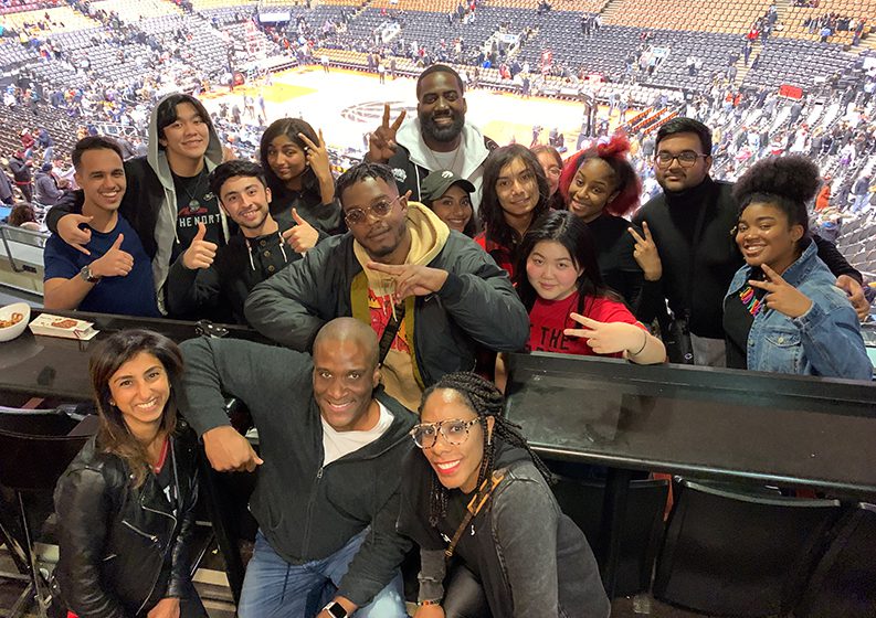 The Black Academy Co-Founders, Shamier Anderson and Stephan James with Monologue Slam students and RBC representatives attending a Toronto Raptors Basketball game.